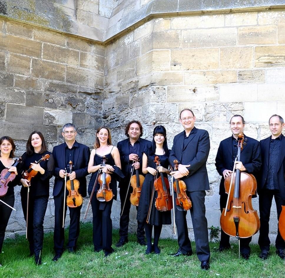 group of people listening to concert