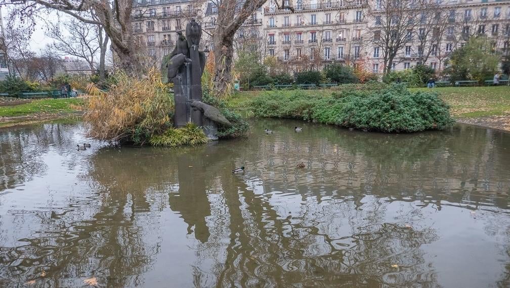 a stone wall with flowers growing on it