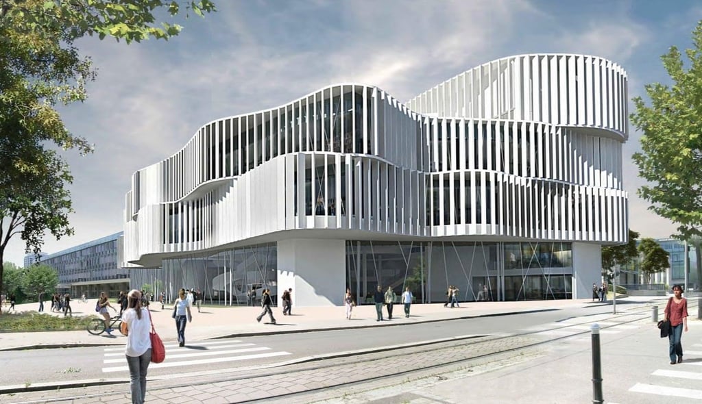 A conference room with a round table and black chairs