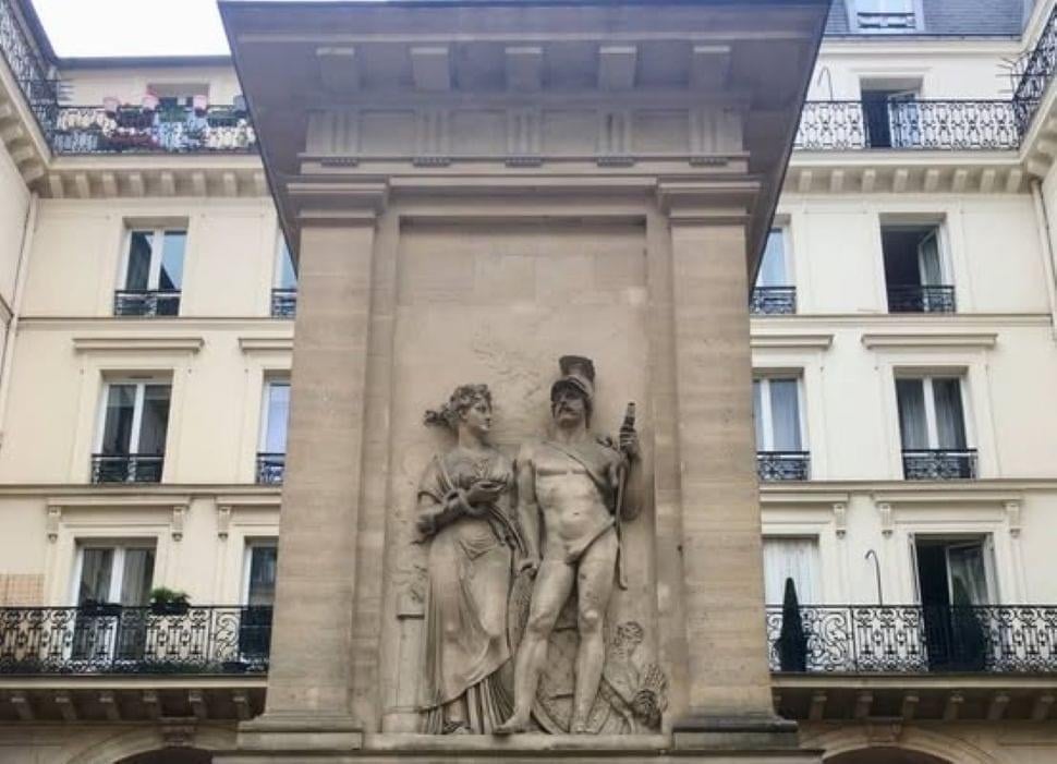 a blue and white handicap parking sign next to a tree