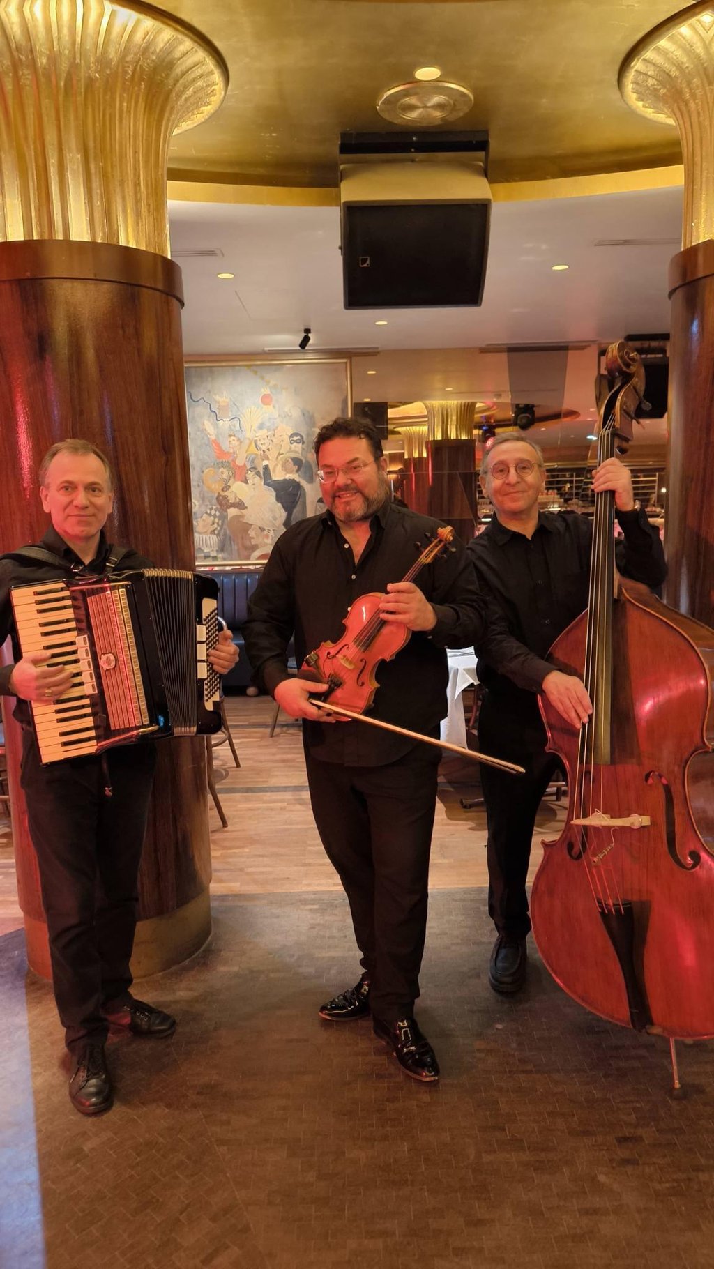 Musicians perform on stage with instruments and drums.