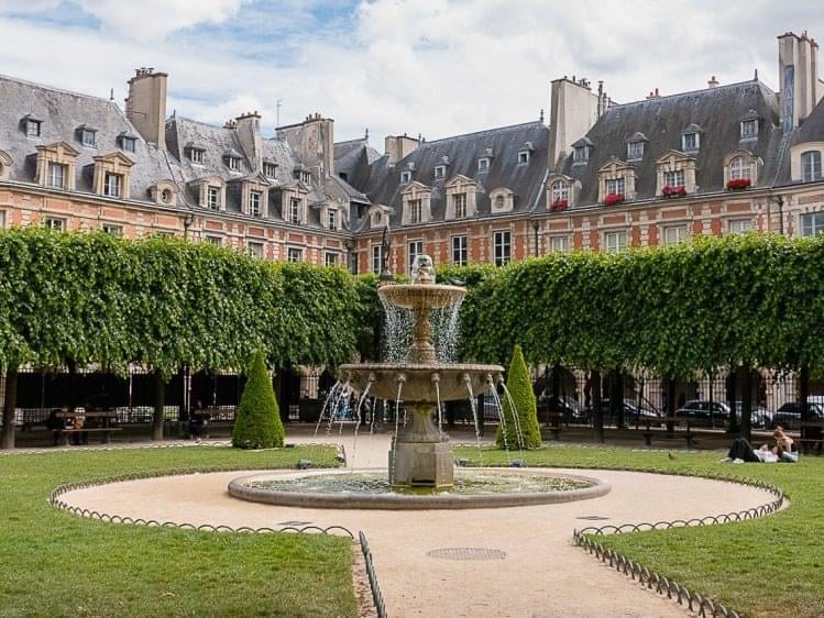 A large building with a fountain in front of it