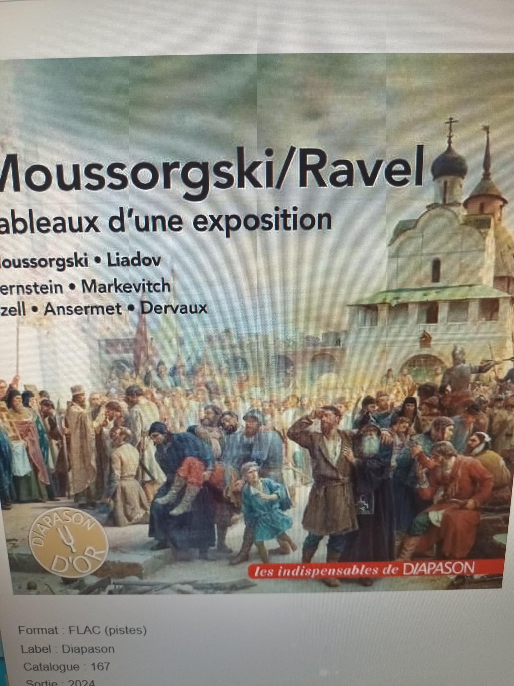 a couple of people standing on top of a sandy hill