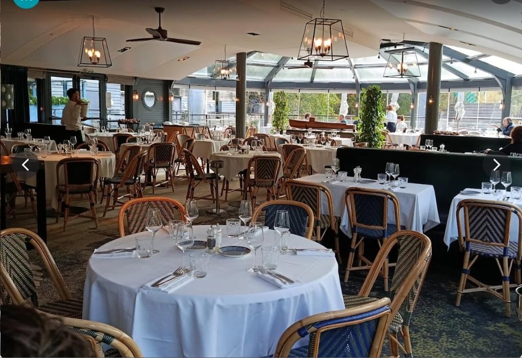 Buildings and trees by a calm body of water.