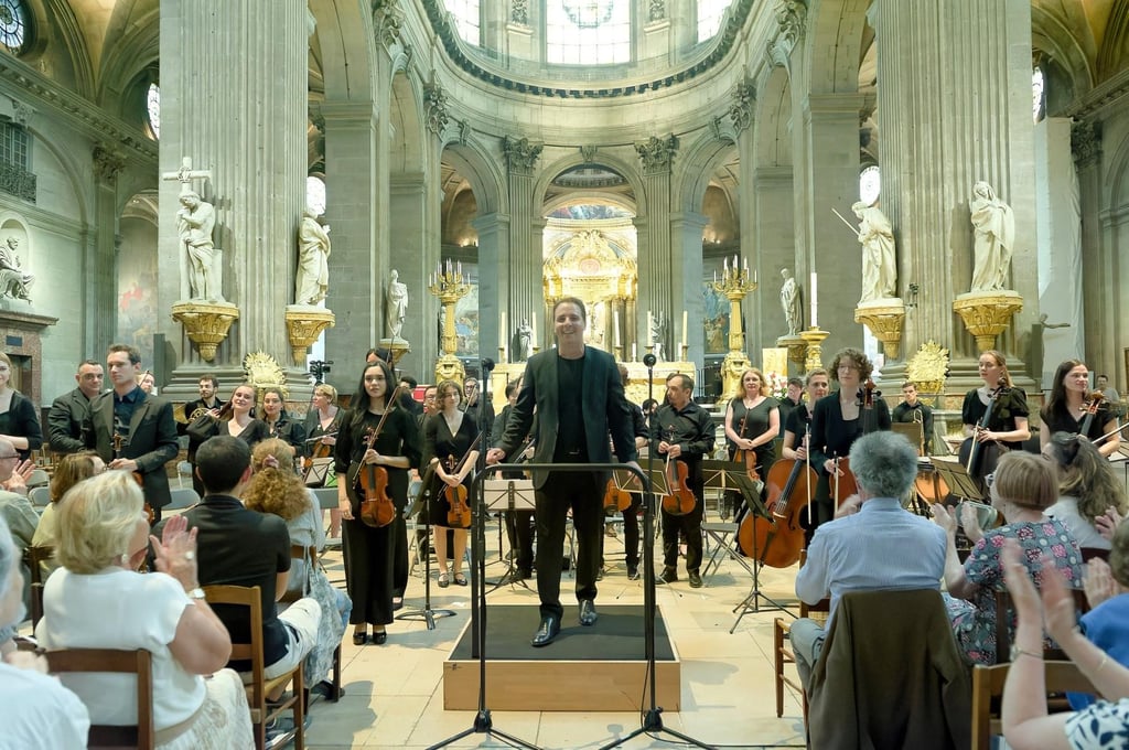An orchestra is performing on a concert stage.