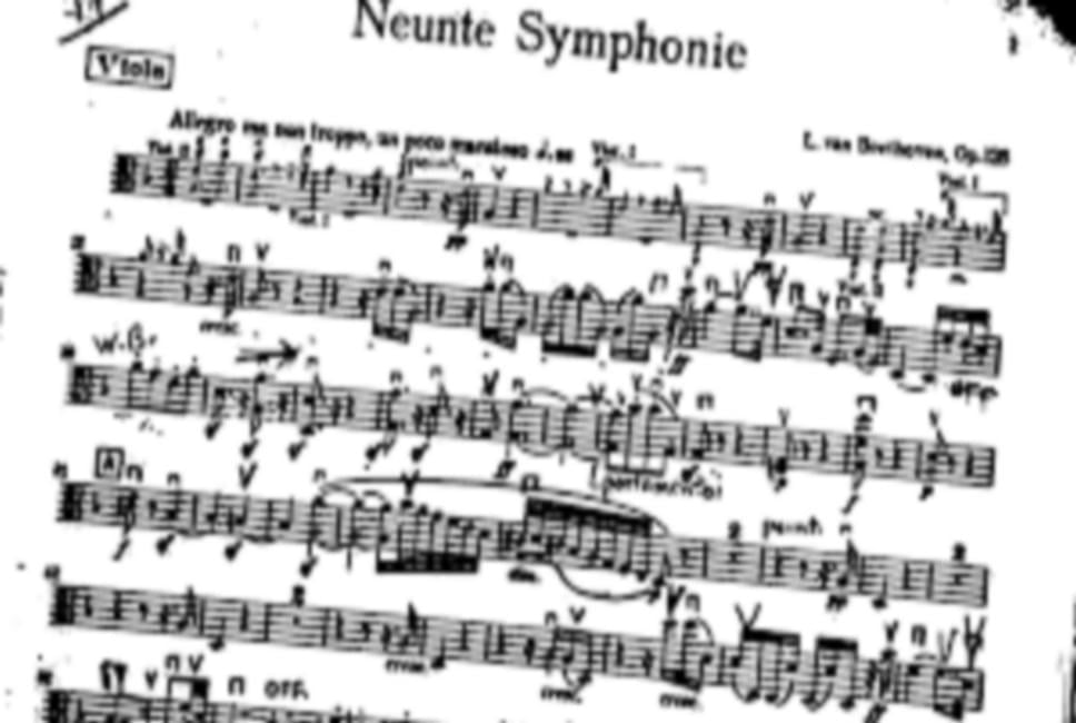 An orchestra is performing on a concert stage.