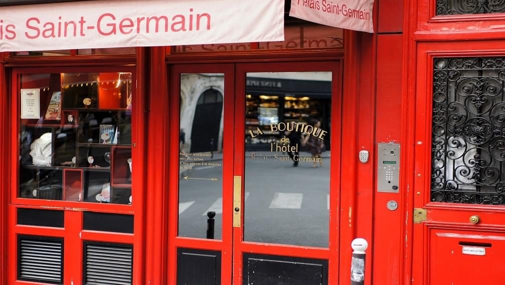 man wearing white shirt standing beside painting screenshot