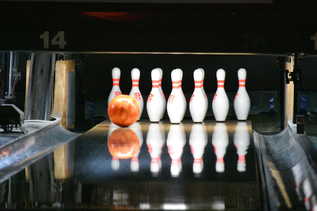 a man standing in front of a bowling alley