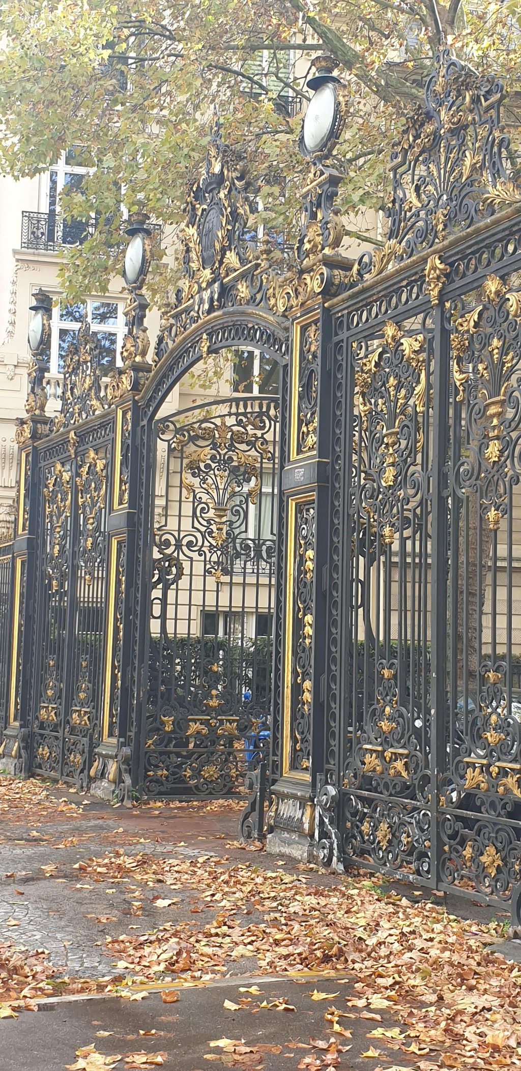 a man walking down a sidewalk in a park