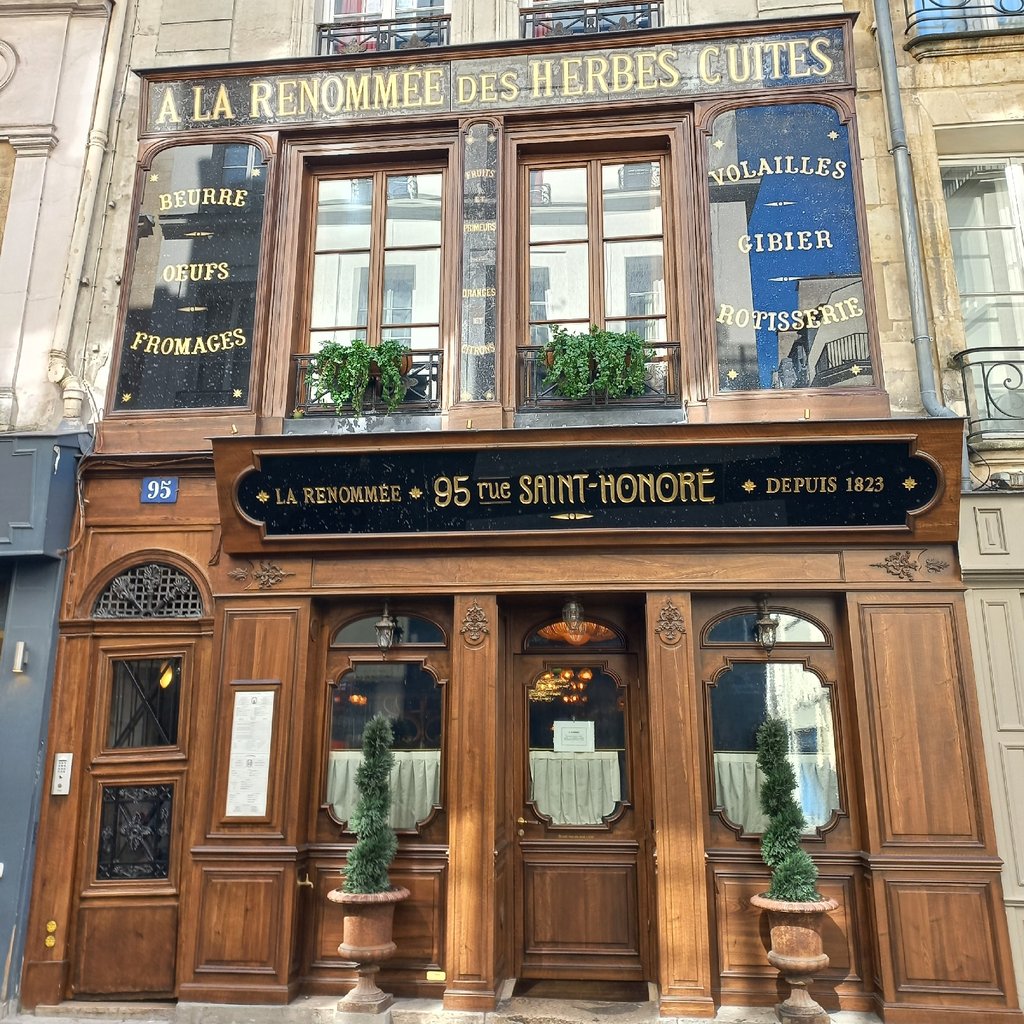 a street corner with a store called souvenirs of paris