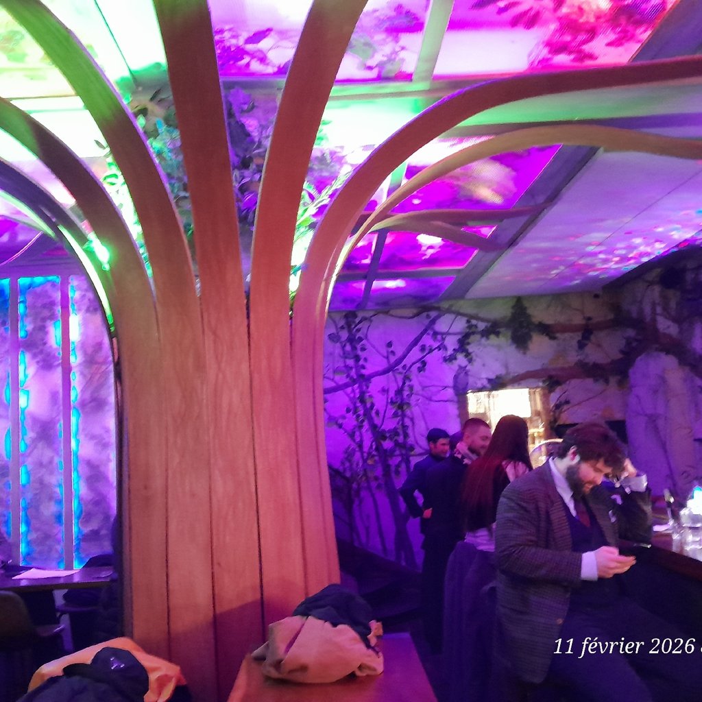 a group of people standing in a bar