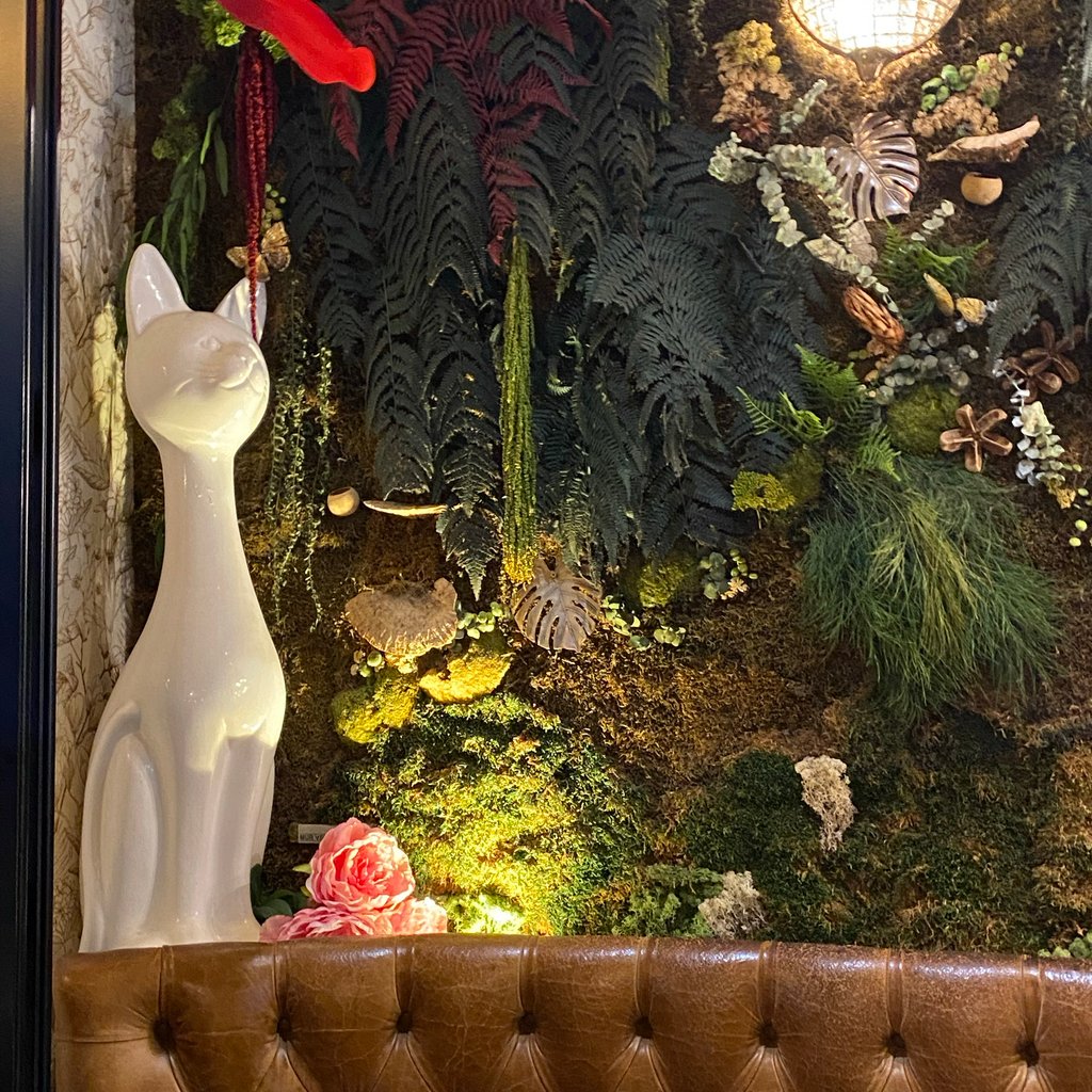 a person sitting at a table with two cups of coffee