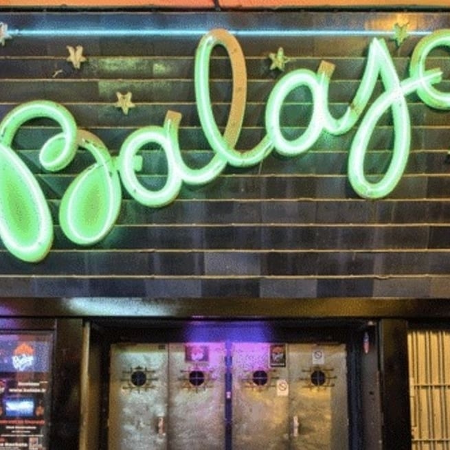 a black and white photo of a person walking in the snow