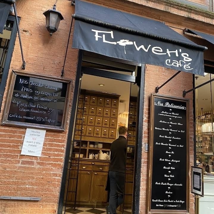 a pink flower in a pot next to a burger king sign