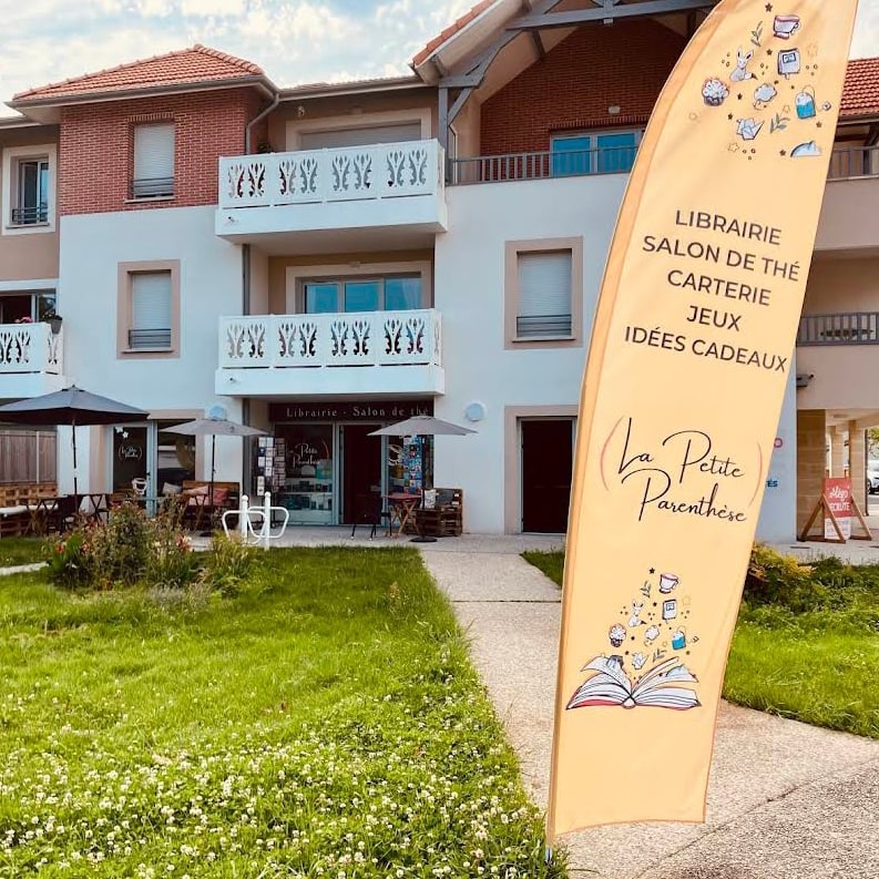 a flower shop with a green awning on a street corner