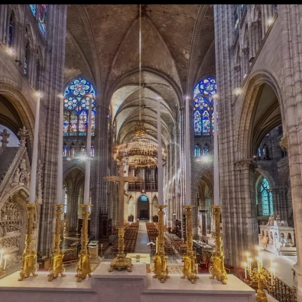 Inside of an old church with rows of pews.