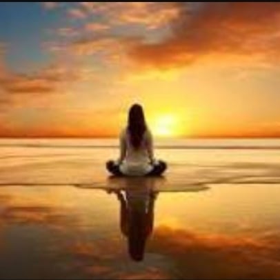 Male yoga teacher vlogger is recording tutorial using smartphone camera in modern studio stretching arms talking sitting on mat. Vlogging and sports concept.