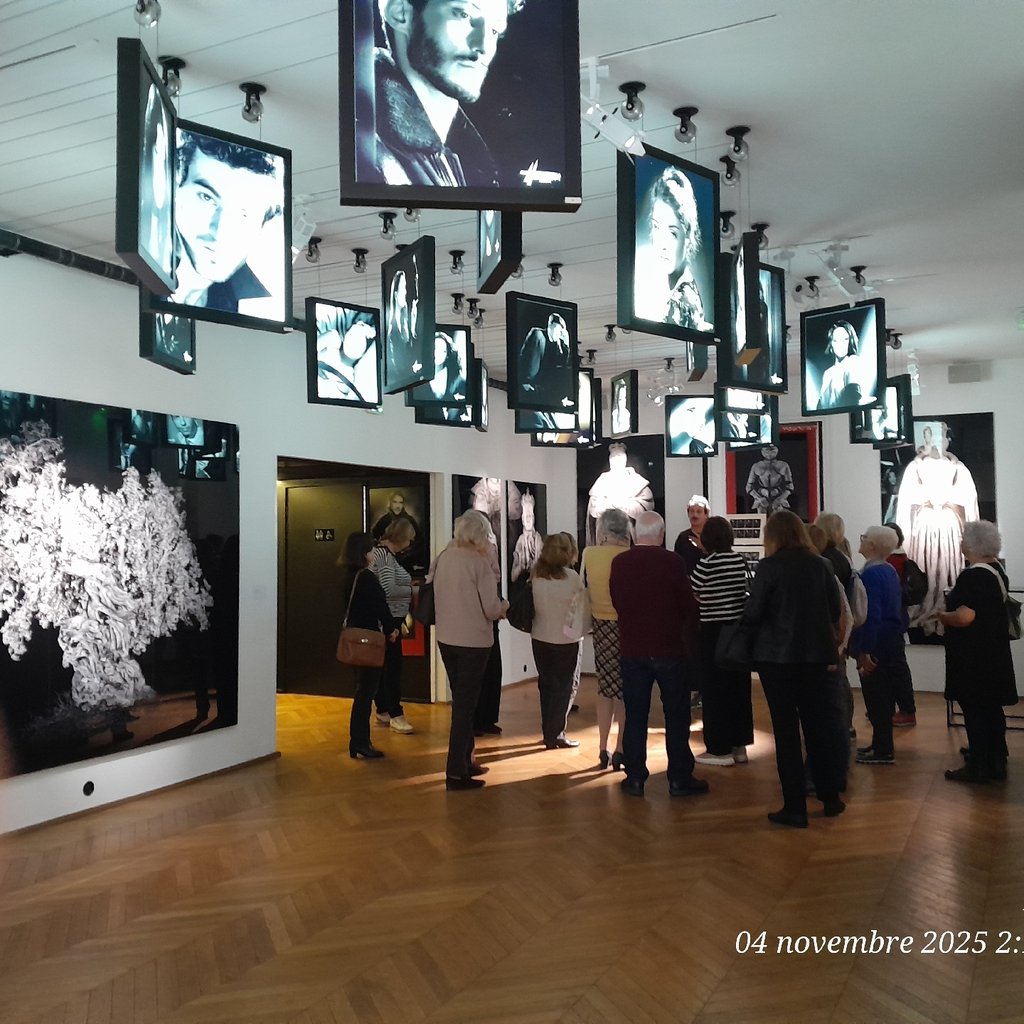 a shelf with statues and plants on top of it