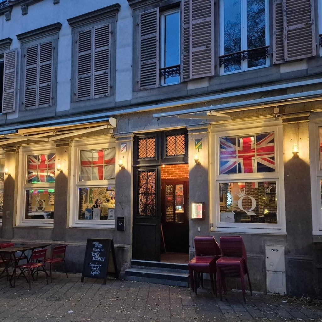 a store front with a statue of a man in the window